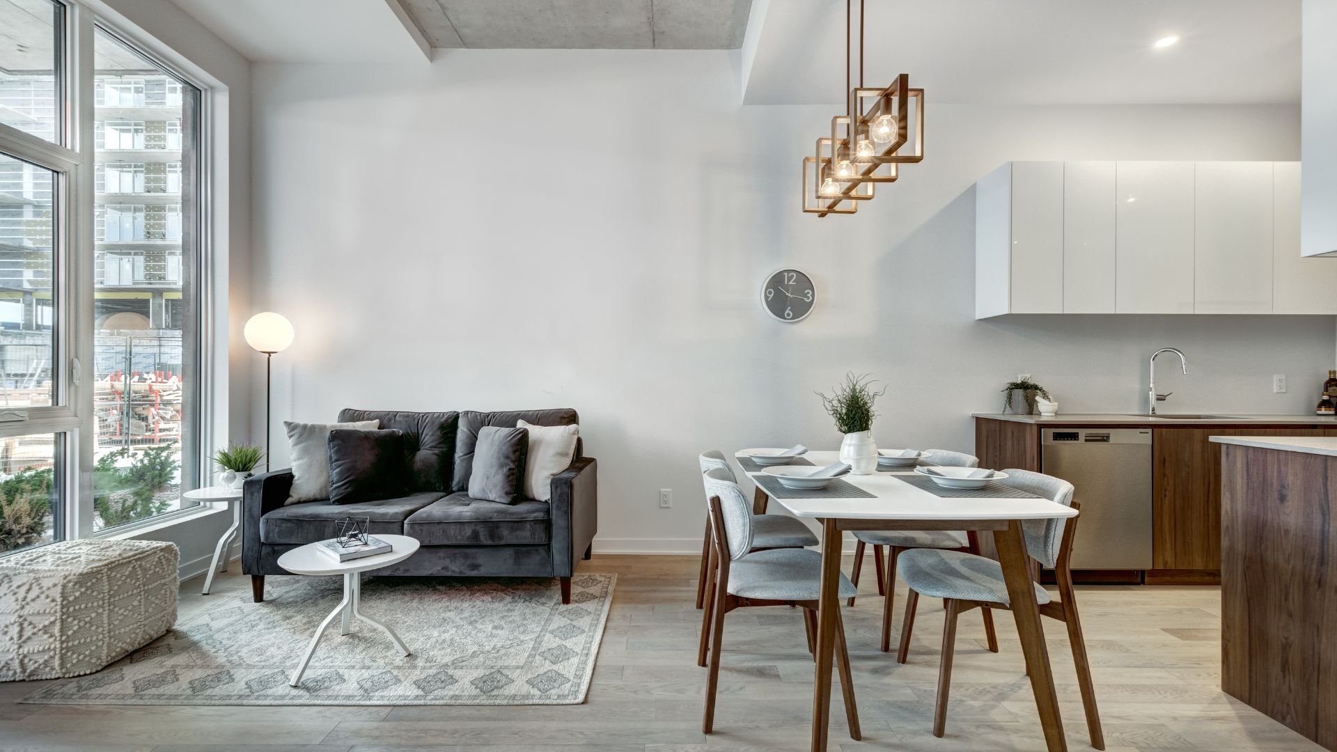 Modern apartment living and dining area with large windows and minimalist design